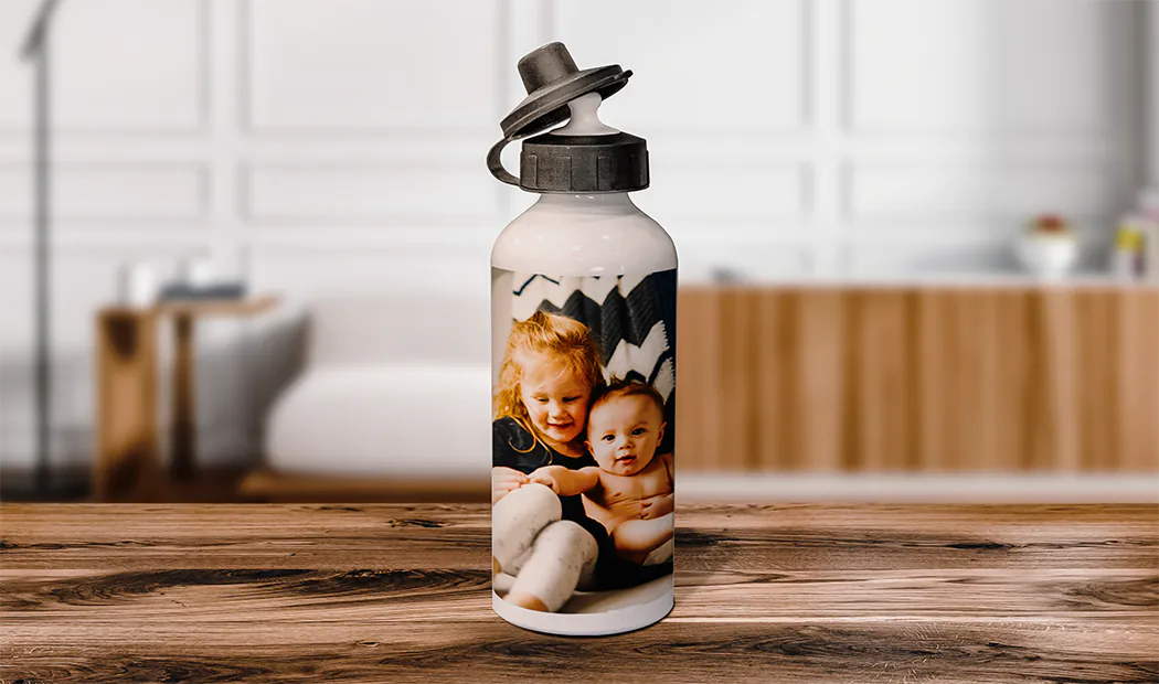 Personalised Photo Bottles|Personalised water bottle; white, featuring a child's photo, black flip-top lid.  Unique gift!|Personalised flamingo water bottle on sandy beach, next to sunglasses & hat.  Perfect summer gift!|Personalised water bottle with a colourful design & fun quote, perfect for weddings.  #Sophie&Brad|||||||
